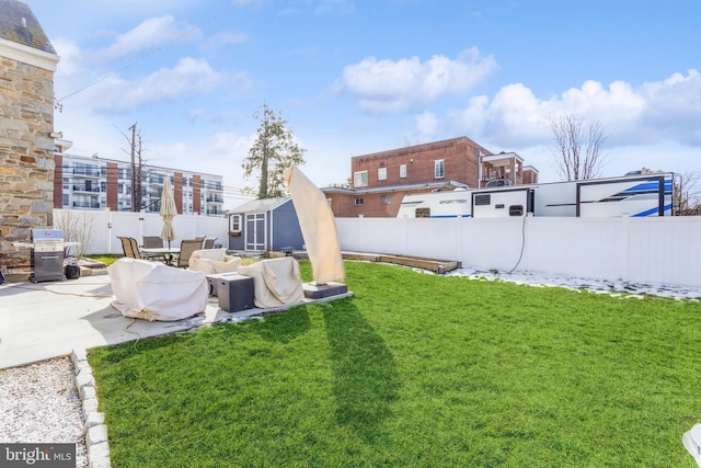 view of yard featuring a storage shed and a patio area