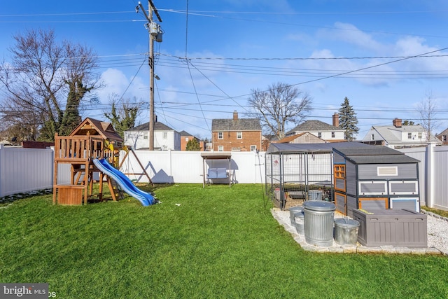 view of yard with a playground and an outbuilding