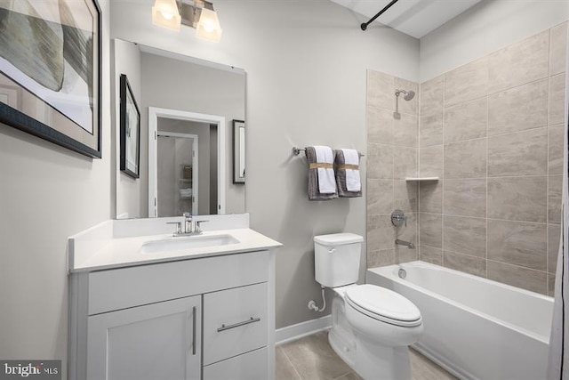 full bathroom featuring tiled shower / bath, vanity, and toilet