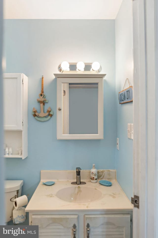 bathroom featuring vanity and toilet