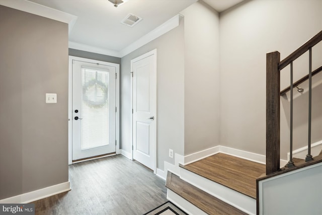 entryway with crown molding and hardwood / wood-style floors