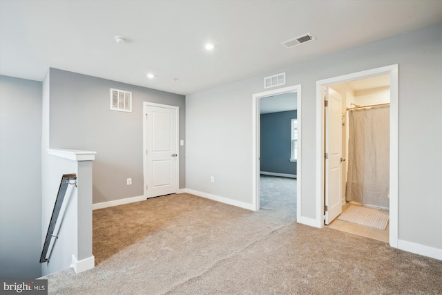 unfurnished living room with light carpet