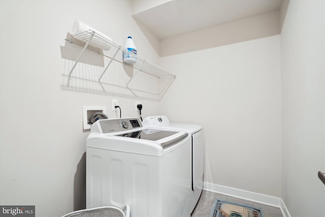 clothes washing area featuring separate washer and dryer