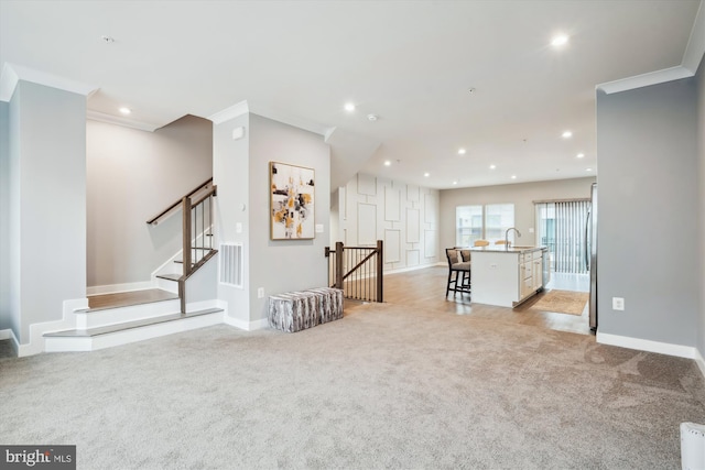 interior space featuring sink, ornamental molding, and light colored carpet