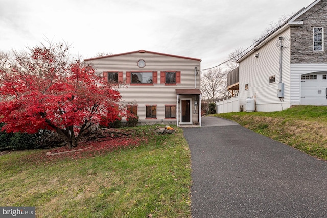 view of front of property featuring a garage and a front yard