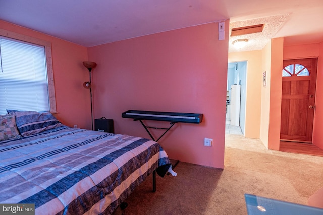 carpeted bedroom featuring white fridge