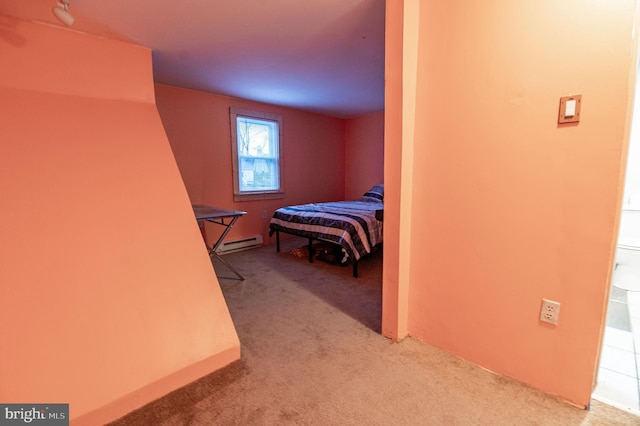 carpeted bedroom featuring baseboard heating