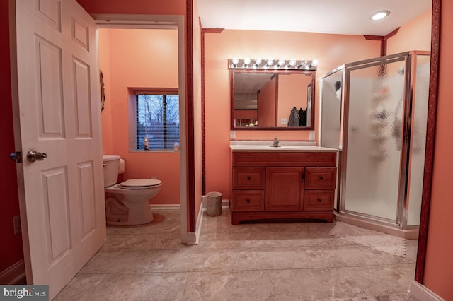 bathroom with an enclosed shower, vanity, and toilet