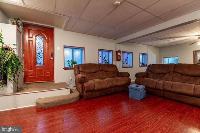 living room with hardwood / wood-style flooring, a baseboard radiator, ceiling fan, and a drop ceiling