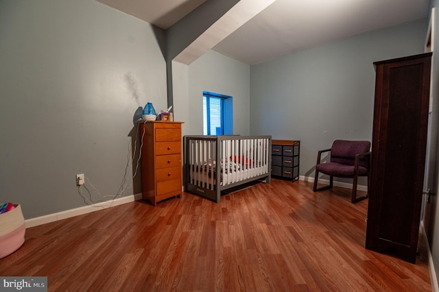 bedroom with hardwood / wood-style floors