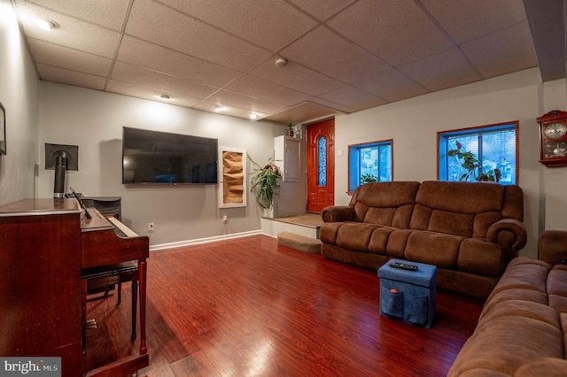 living room with a drop ceiling and hardwood / wood-style floors