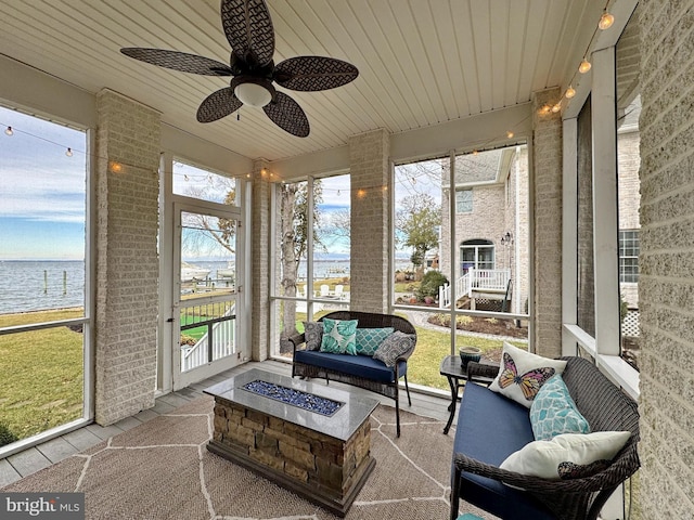 sunroom with a water view, ceiling fan, and wooden ceiling