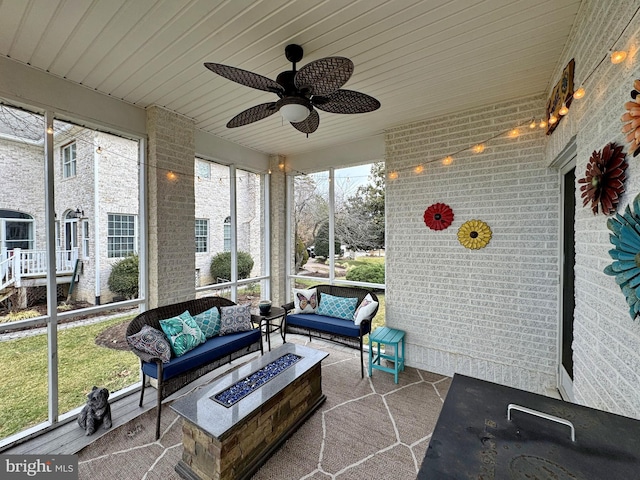 sunroom with wooden ceiling and ceiling fan