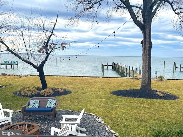 dock area featuring a yard and a water view