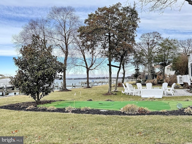 view of community featuring a yard and a water view