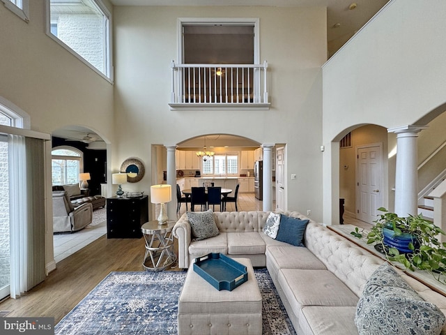 living room with hardwood / wood-style flooring and ornate columns