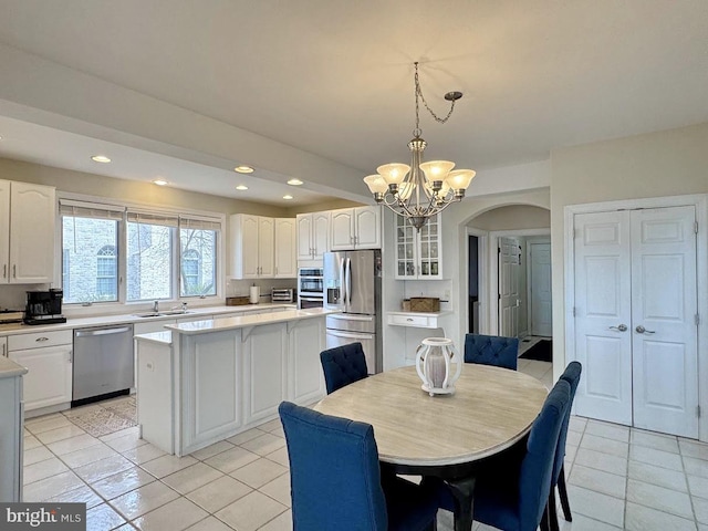 dining room featuring light tile patterned floors and a notable chandelier