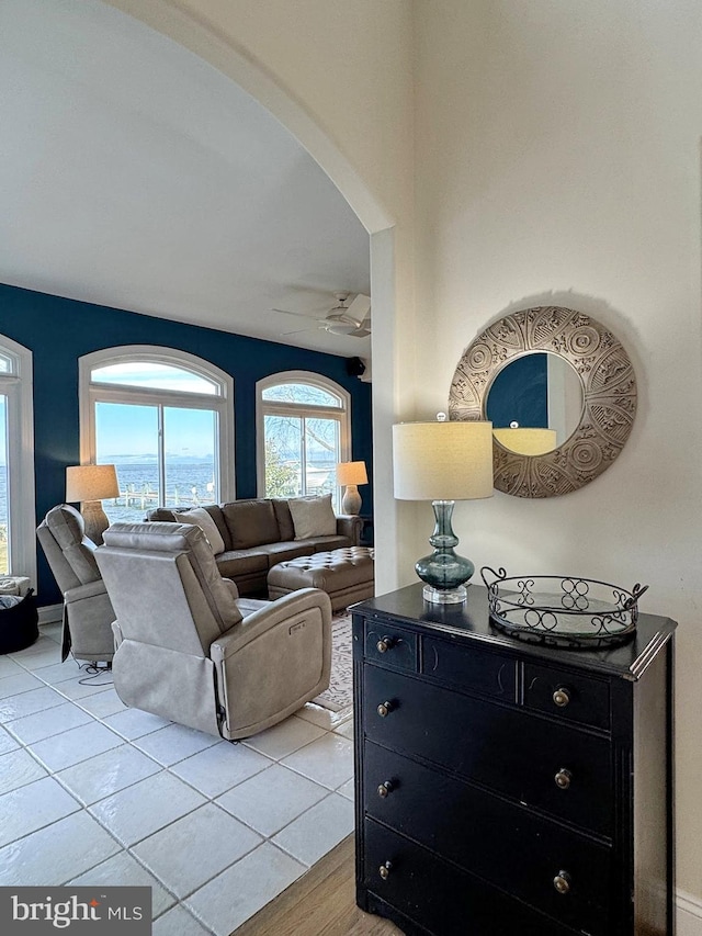 tiled living room with ceiling fan