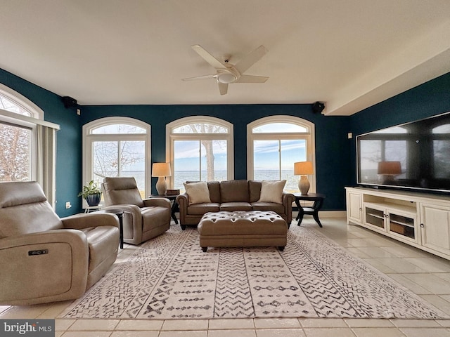 living room with ceiling fan and light tile patterned flooring