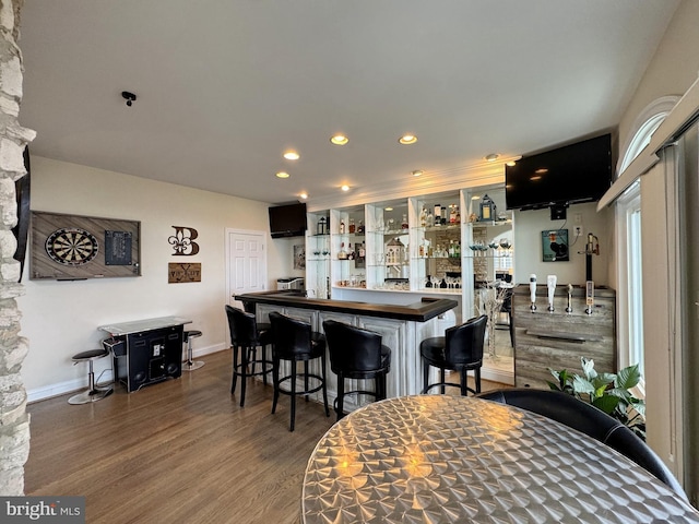 kitchen featuring dark wood-type flooring and a kitchen bar