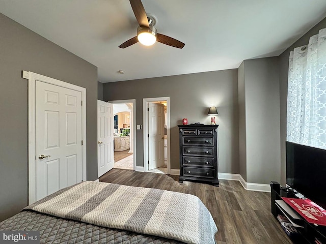 bedroom with ceiling fan and dark hardwood / wood-style flooring