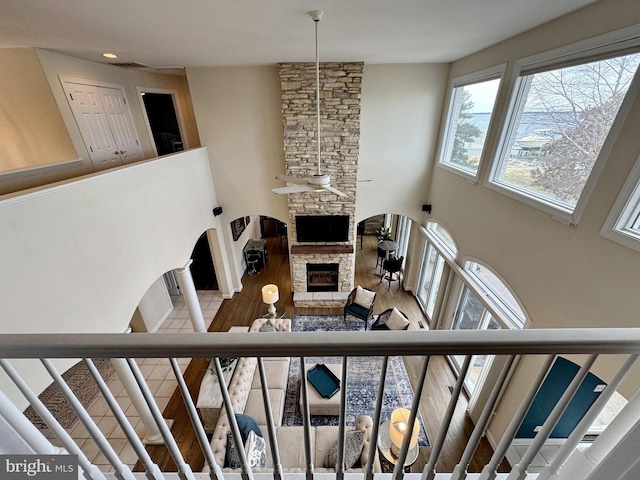 staircase featuring hardwood / wood-style floors and a fireplace