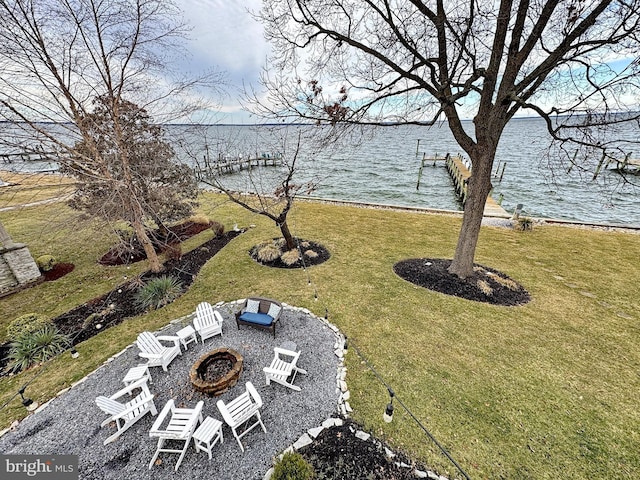 view of yard featuring a fire pit and a water view