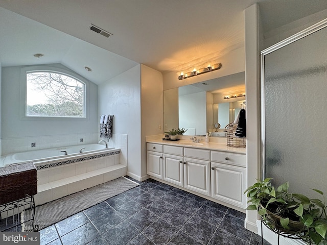 bathroom featuring lofted ceiling, shower with separate bathtub, and vanity