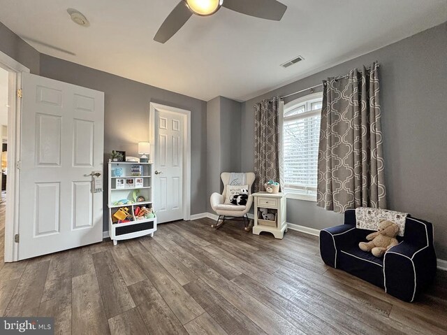 sitting room featuring ceiling fan and hardwood / wood-style floors