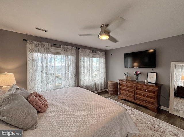 bedroom featuring dark hardwood / wood-style floors and ceiling fan