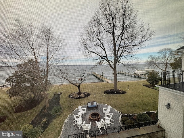 view of yard with a water view and a fire pit