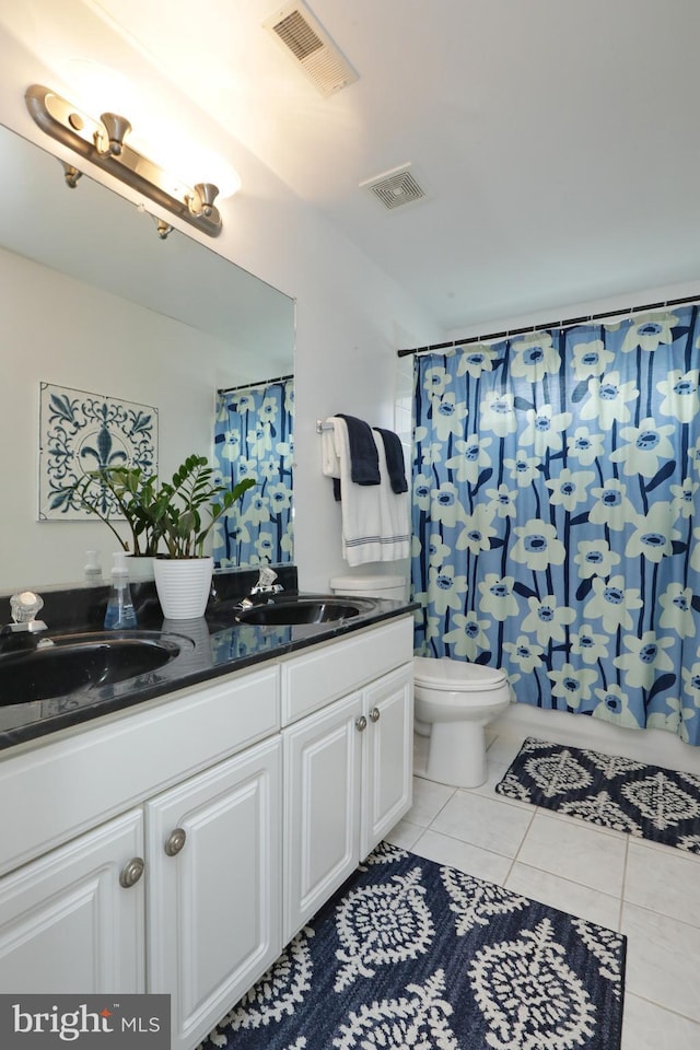 bathroom with vanity, tile patterned floors, and toilet