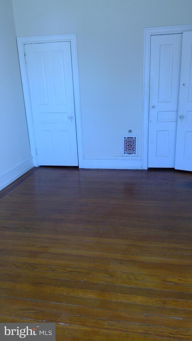 empty room featuring dark hardwood / wood-style floors