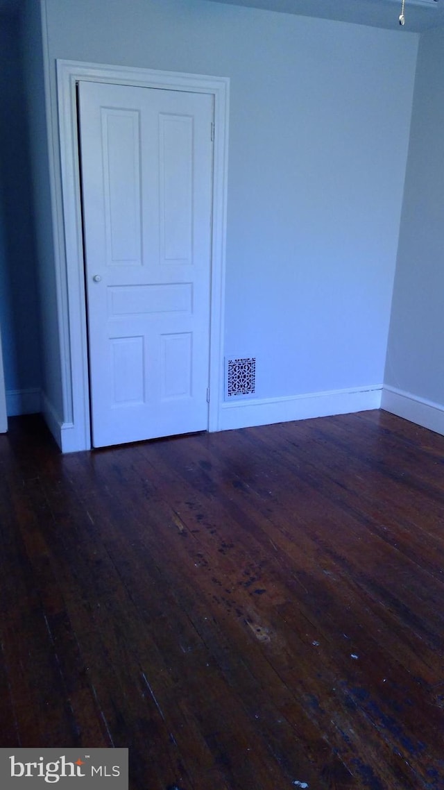 spare room featuring dark hardwood / wood-style flooring