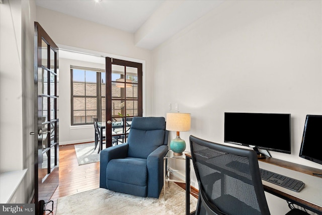 office area with french doors, baseboards, and wood finished floors