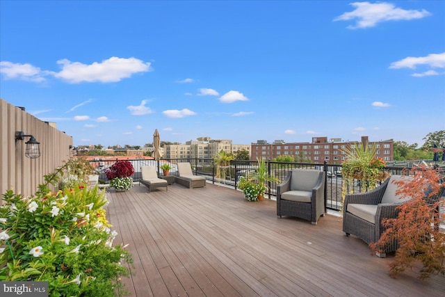 wooden terrace featuring a view of city