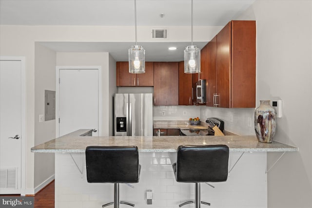 kitchen with visible vents, backsplash, a peninsula, and stainless steel appliances