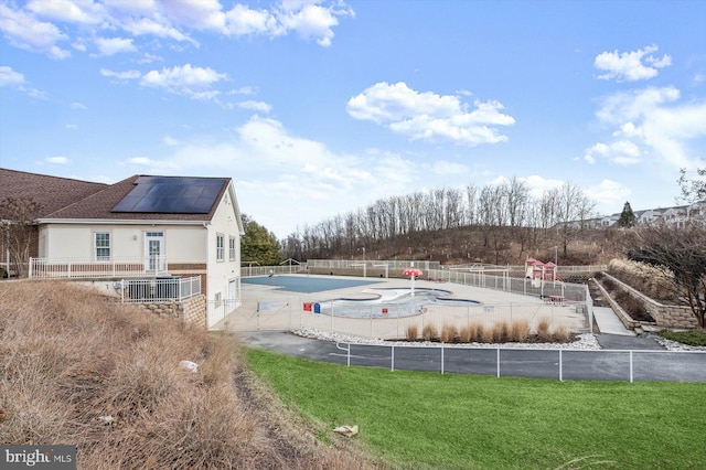 view of pool featuring a yard