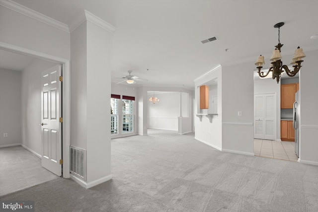 unfurnished living room with crown molding, ceiling fan with notable chandelier, and light carpet