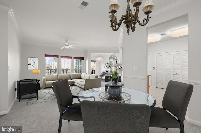 dining area featuring crown molding, ceiling fan with notable chandelier, and light colored carpet