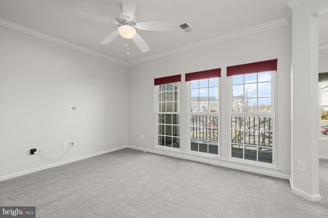 carpeted spare room featuring ceiling fan and ornamental molding