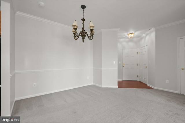 spare room with ornamental molding, dark carpet, and a notable chandelier