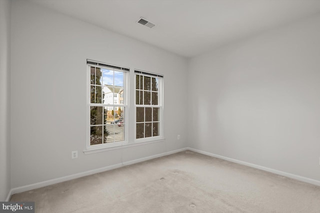 unfurnished room with light colored carpet