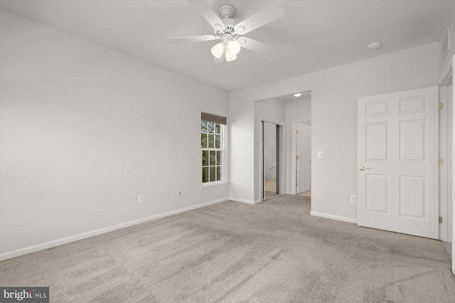 carpeted empty room featuring ceiling fan