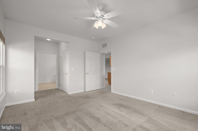 unfurnished bedroom with ceiling fan and light carpet