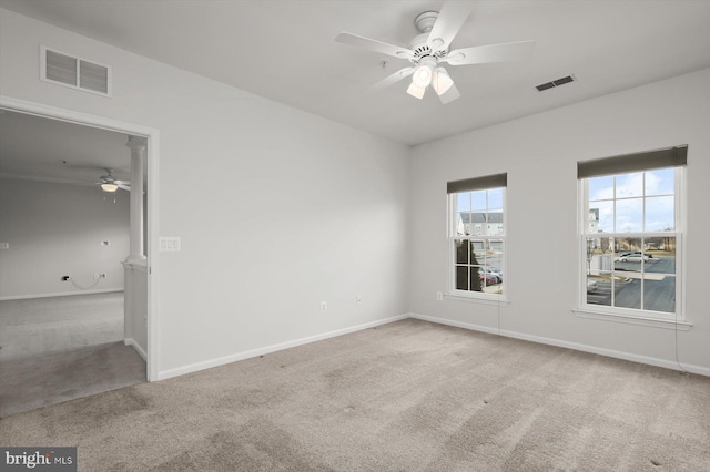 empty room featuring light colored carpet and ceiling fan