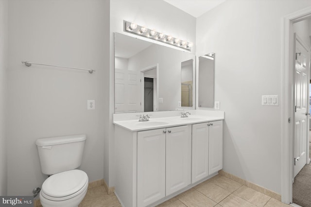 bathroom featuring vanity, toilet, and tile patterned flooring