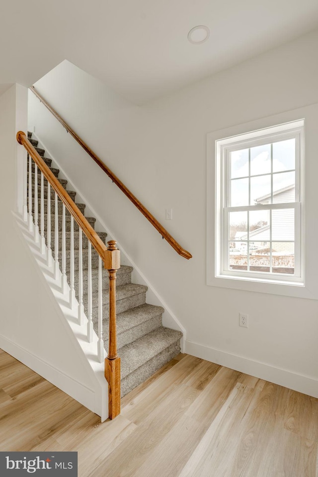 staircase featuring hardwood / wood-style flooring