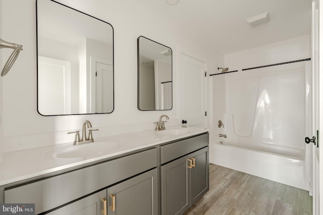 bathroom featuring vanity, bathtub / shower combination, and hardwood / wood-style floors