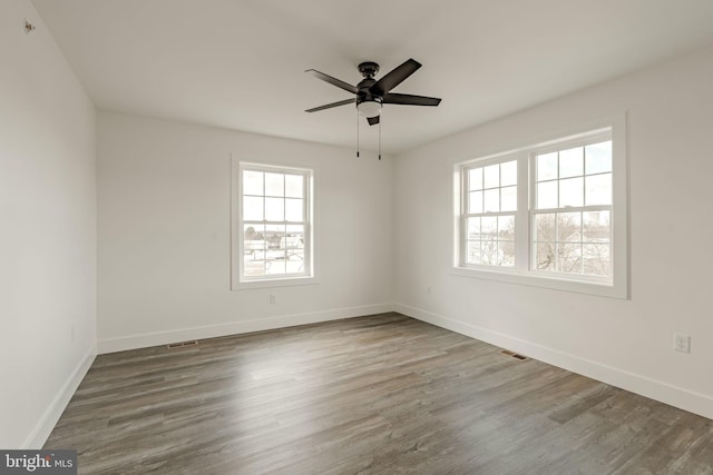 unfurnished room with wood-type flooring and ceiling fan